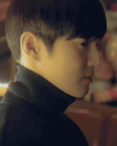 A Close Up Of A Person 'S Face With A Turtleneck GIF