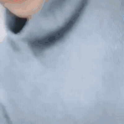 A Close Up Of A Person 'S Face With A Turtleneck And A Blue Shirt . GIF