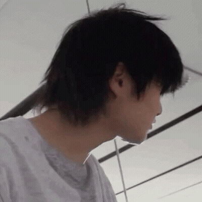 A Close Up Of A Person 'S Face With A Very Long Black Haircut . GIF