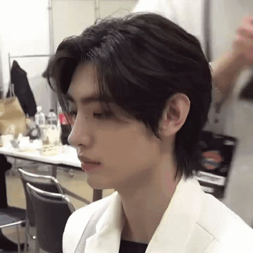 A Close Up Of A Person 'S Face With A Very Long Haircut . GIF