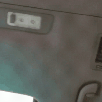 A Close Up Of A Person 'S Face With A White Light On The Ceiling GIF