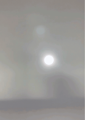 A Close Up Of A Person 'S Face With A White Light Shining On It GIF