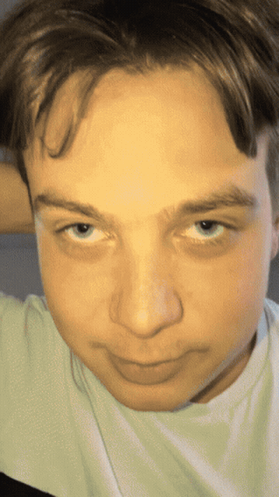 A Close Up Of A Person 'S Face With A White Shirt GIF