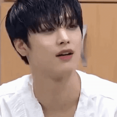 A Close Up Of A Person 'S Face With A White Shirt On And A Black Haircut . GIF