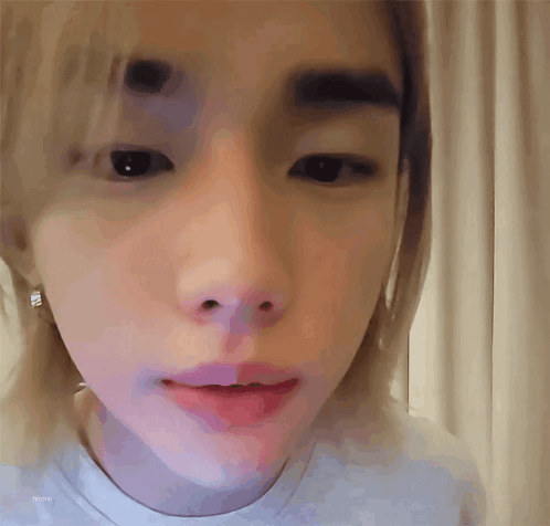 A Close Up Of A Person 'S Face With A White Shirt On GIF