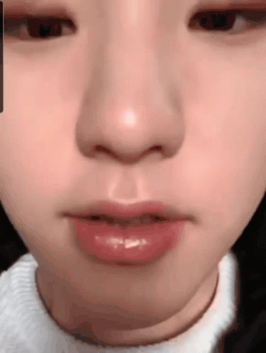 A Close Up Of A Person 'S Face With A White Sweater On GIF