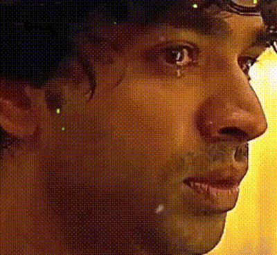 A Close Up Of A Person 'S Face With A Yellow Background GIF