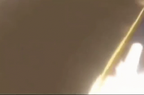A Close Up Of A Person 'S Face With A Yellow Flame Coming Out Of It 'S Mouth . GIF