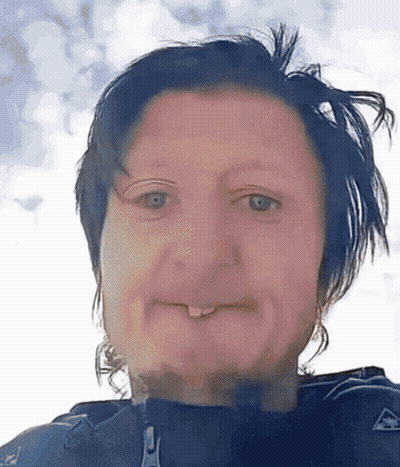 A Close Up Of A Person 'S Face With A Zipper On Their Jacket Visible GIF