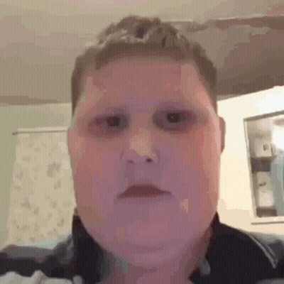 A Close Up Of A Person 'S Face With Black Eyes And A Purple Background . GIF