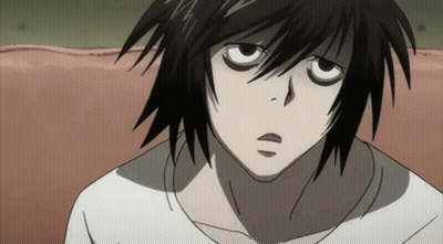 A Close Up Of A Person 'S Face With Black Hair And A White Shirt . GIF