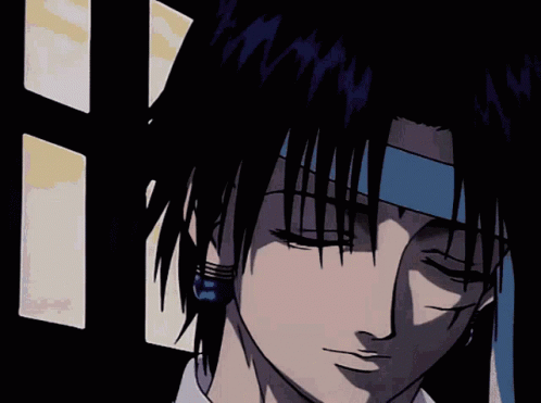 A Close Up Of A Person 'S Face With Blue Earrings On GIF