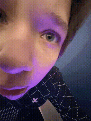 A Close Up Of A Person 'S Face With Blue Eyes GIF