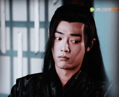 A Close Up Of A Person 'S Face With Chinese Writing On The Bottom Right GIF