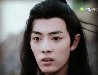 A Close Up Of A Person 'S Face With Chinese Writing On The Bottom Right GIF