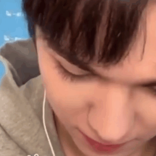 A Close Up Of A Person 'S Face With Earphones In Their Ears . GIF