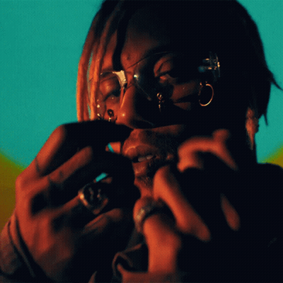 A Close Up Of A Person 'S Face With Glasses And Rings On Their Fingers GIF