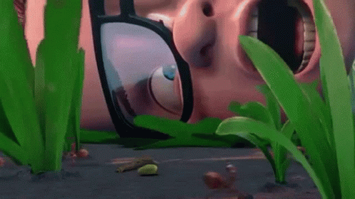 A Close Up Of A Person 'S Face With Glasses On Surrounded By Plants . GIF
