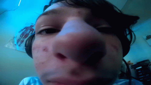 A Close Up Of A Person 'S Face With Headphones GIF