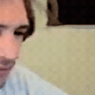 A Close Up Of A Person 'S Face With Headphones On And Their Eyes Closed . GIF