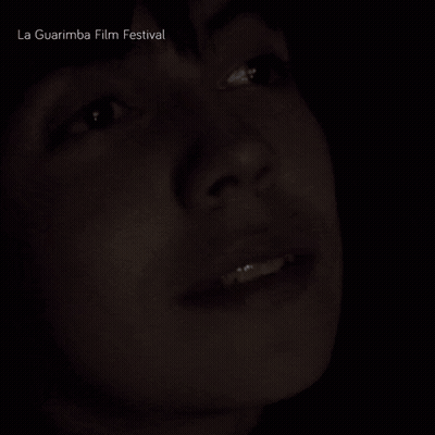 A Close Up Of A Person 'S Face With La Guarimba Film Festival Written Above GIF