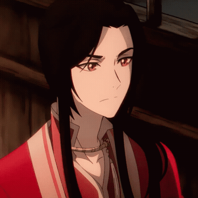 A Close Up Of A Person 'S Face With Long Black Hair And Red Eyes GIF