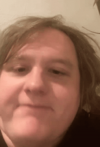 A Close Up Of A Person 'S Face With Long Hair GIF