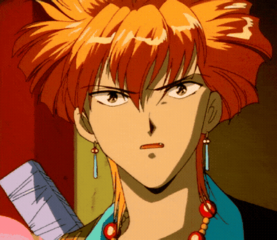A Close Up Of A Person 'S Face With Orange Hair And Earrings GIF