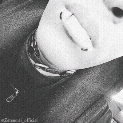 A Close Up Of A Person 'S Face With Piercings On Their Lips And Neck . GIF
