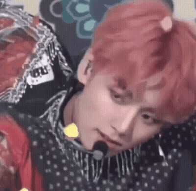 A Close Up Of A Person 'S Face With Pink Hair And A Microphone In Their Mouth . GIF