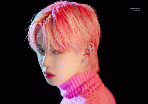 A Close Up Of A Person 'S Face With Pink Hair And A Pink Sweater GIF