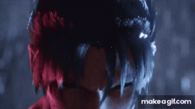 A Close Up Of A Person 'S Face With Red And Black Hair . GIF