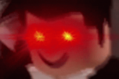 A Close Up Of A Person 'S Face With Red Eyes And A Smile On Their Face . GIF