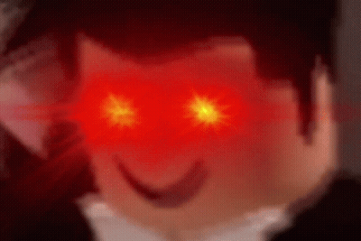 A Close Up Of A Person 'S Face With Red Eyes Glowing . GIF