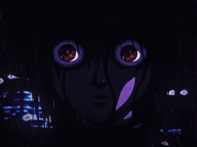 A Close Up Of A Person 'S Face With Red Eyes In A Dark Room GIF