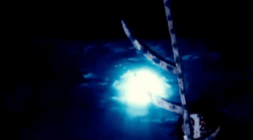 A Close Up Of A Person 'S Face With Red Eyes In A Dark Room . GIF
