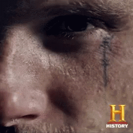 A Close Up Of A Person 'S Face With The Letter H On The Bottom GIF