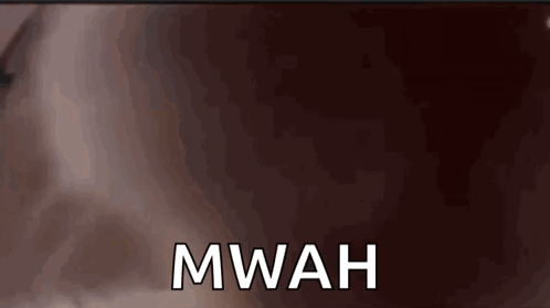 A Close Up Of A Person 'S Face With The Word Mwah On It GIF