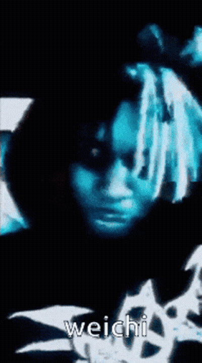 A Close Up Of A Person 'S Face With The Word Weichi On The Bottom Right GIF
