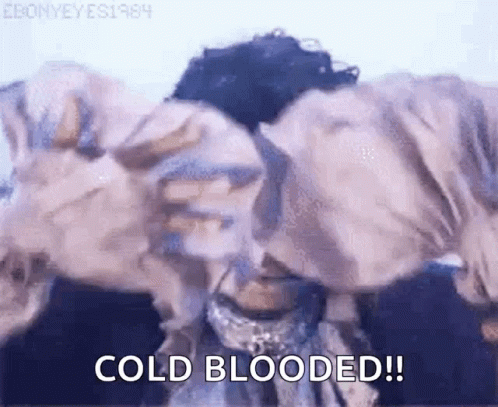 A Close Up Of A Person 'S Face With The Words `` Cold Blooded '' Written In The Corner . GIF