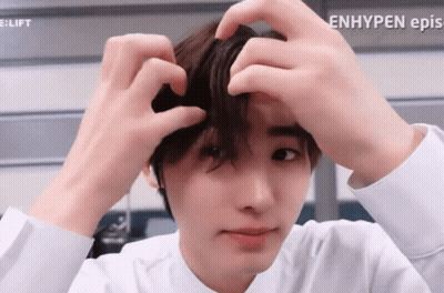A Close Up Of A Person 'S Face With The Words Enhypen Ep.s. Visible GIF