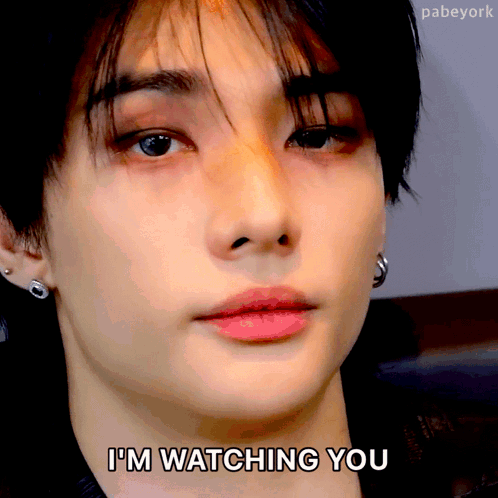 A Close Up Of A Person 'S Face With The Words " I 'M Watching You " Written Below It GIF