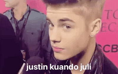 A Close Up Of A Person 'S Face With The Words `` Justin Kuando Juli '' Written On The Bottom . GIF