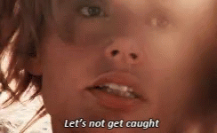 A Close Up Of A Person 'S Face With The Words `` Let 'S Not Get Caught '' Written Above It . GIF