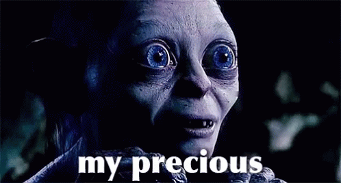 A Close Up Of A Person 'S Face With The Words `` My Precious '' Written Below It . GIF