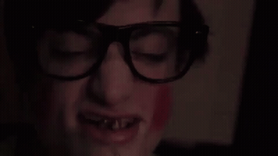 A Close Up Of A Person 'S Face With The Words - Skanu ! Written In Yellow GIF