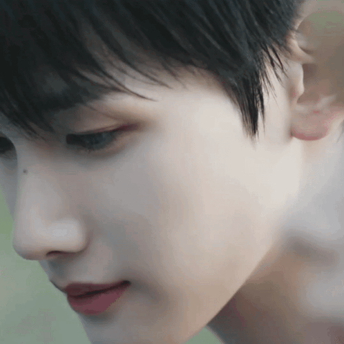 A Close Up Of A Person 'S Face With Their Ear In The Foreground GIF