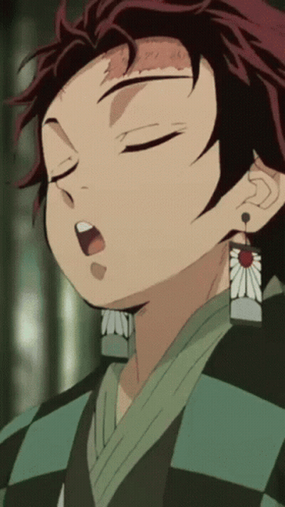 A Close Up Of A Person 'S Face With Their Eyes Closed And A Flower Earring GIF