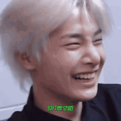 A Close Up Of A Person 'S Face With Their Eyes Closed And A Smile On Their Face . GIF