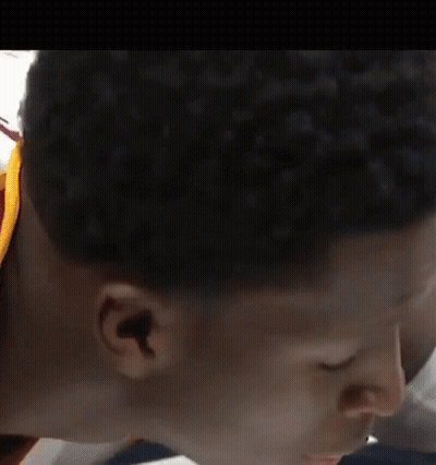 A Close Up Of A Person 'S Face With Their Eyes Closed And A White Shirt On . GIF